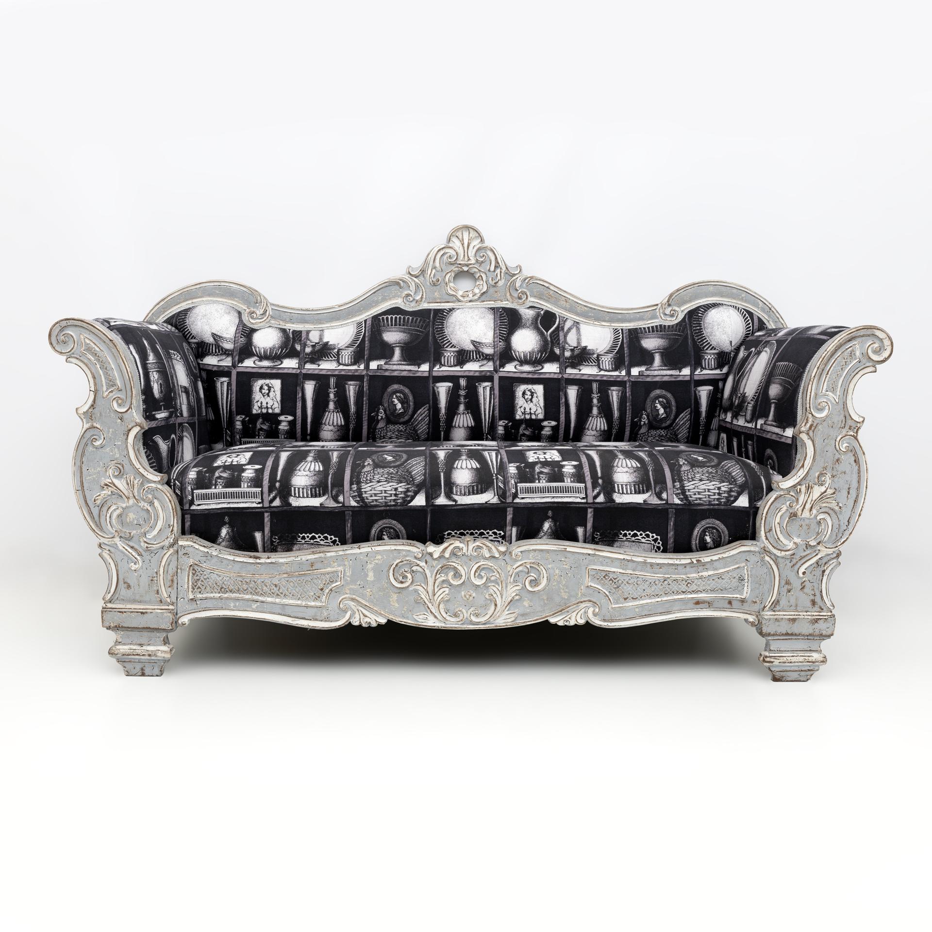 This Carlo X style boat sofa comes from a nineteenth-century villa on Lake Como, the gray and white lacquered sofa, shabby chic effect, has been upholstered with original Fornasetti linen fabric, see signature as shown in the photo.