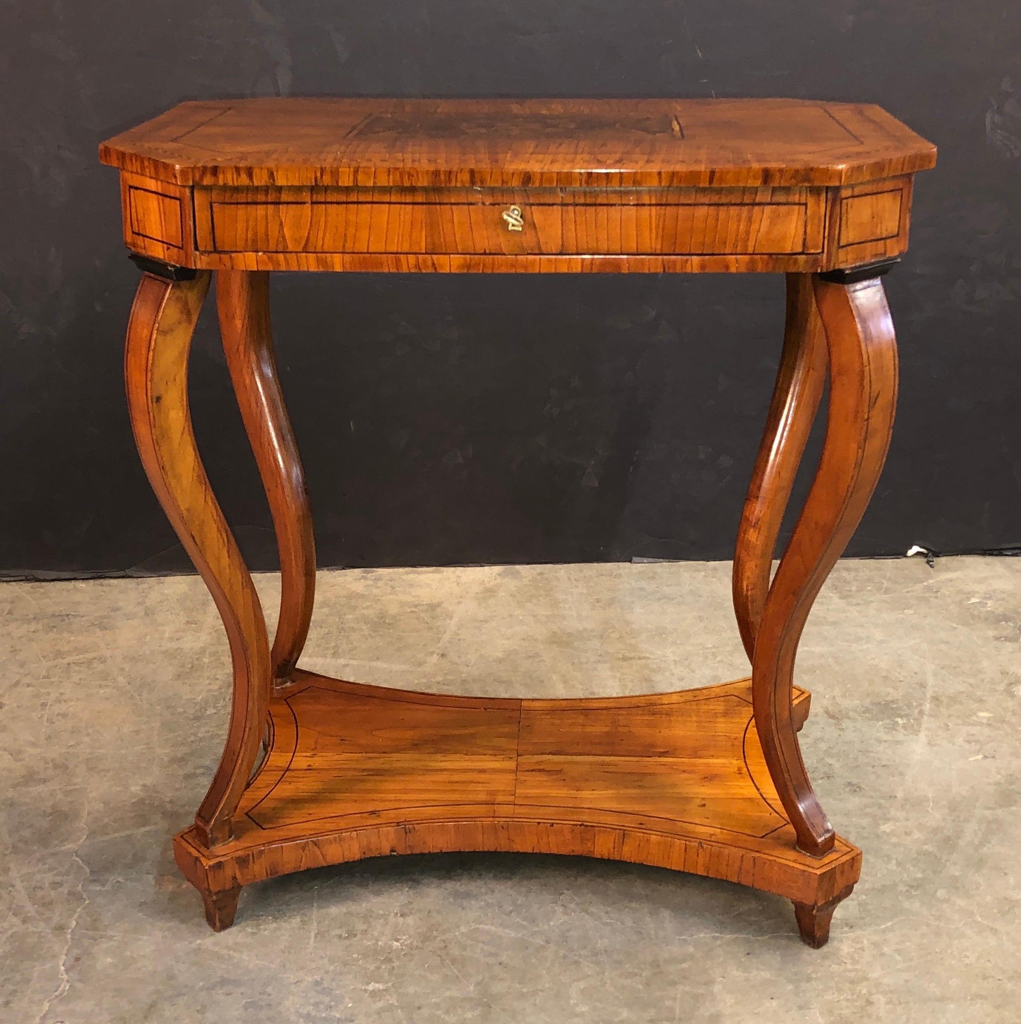 An unusual French Charles X walnut and fine marquetry inlaid one drawer side table with a shelf stretcher base,