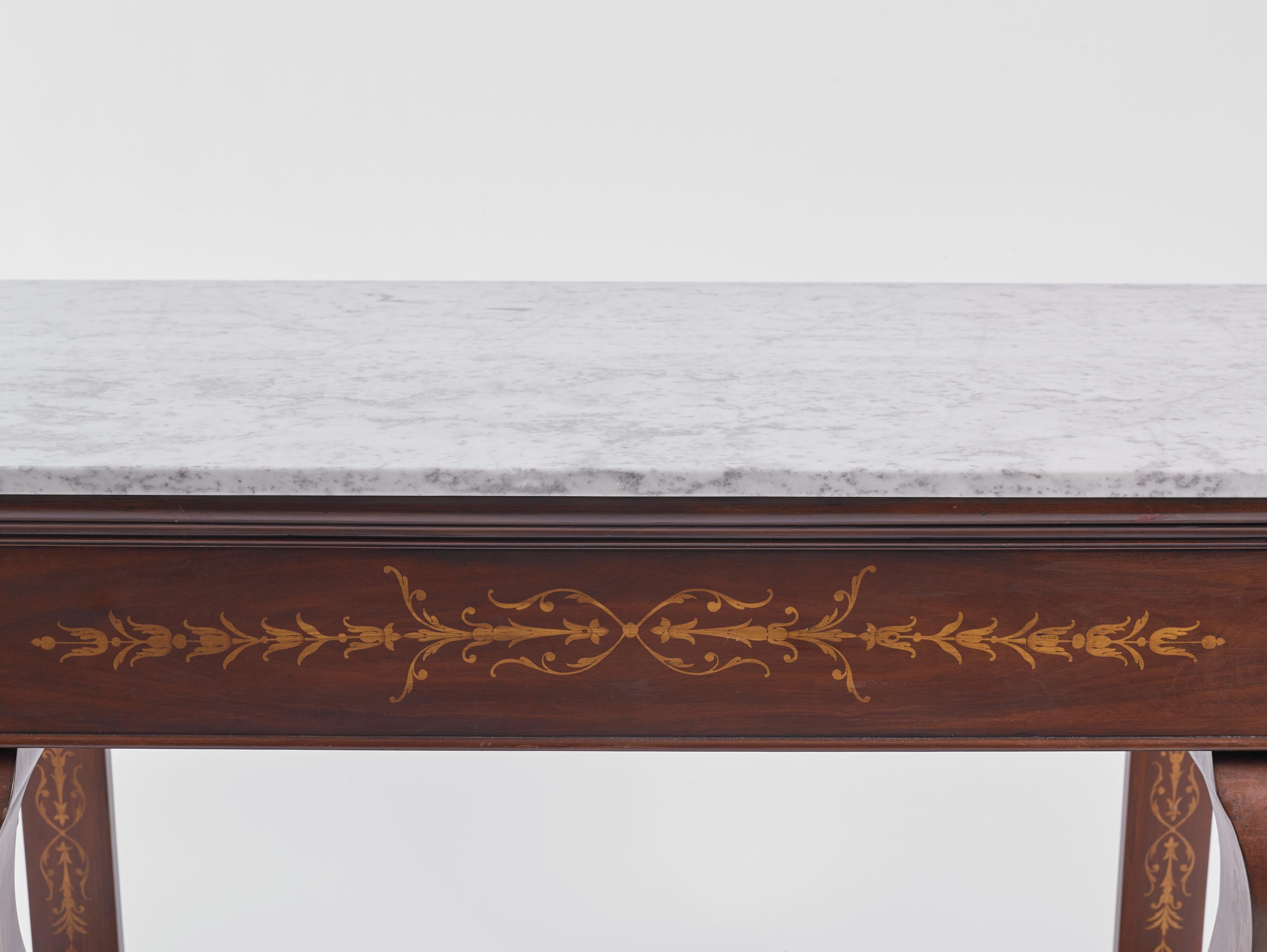 Acquired at an estate sale in Italy, and imported from abroad, this is a Charles  X-period (1757 - 1836) console with a Carrara marble surface that has inlaid wood floral and foliate marquetry on the front, as well as both sides. 

It measures