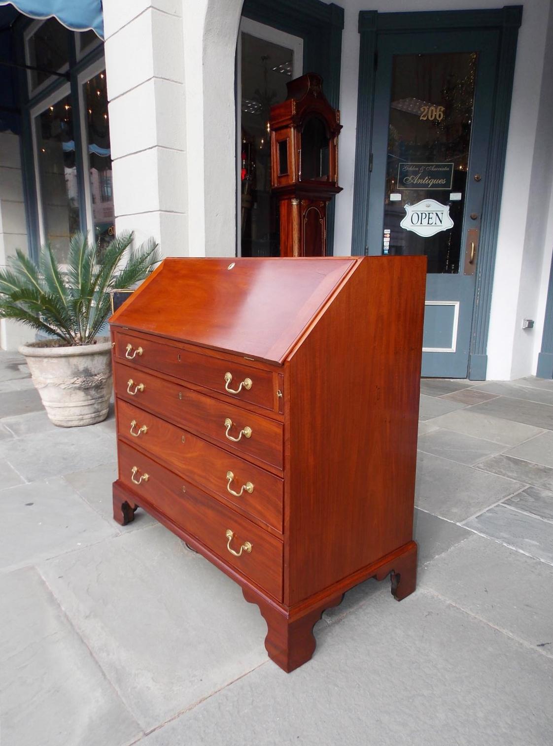 Charleston Chippendale mahogany slant top writing desk with four graduated drawers, fitted interior, original brasses, and resting on the original bracket feet. Late 18th century. Secondary wood consist of Spanish cedra.