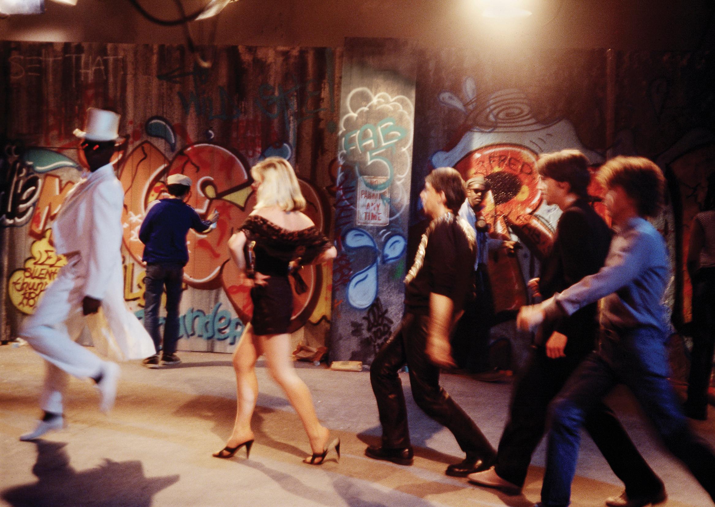 Charlie Ahearn, "Rapture" (in motion) 1981:
A rare historic Debbie Harry, Fab 5 Freddy & Lee Quinones photograph captured by Wild Style director Charlie Ahearn on the set of Blondie's "Rapture".  

Medium: Archival Inkjet Print on heavy-weight
