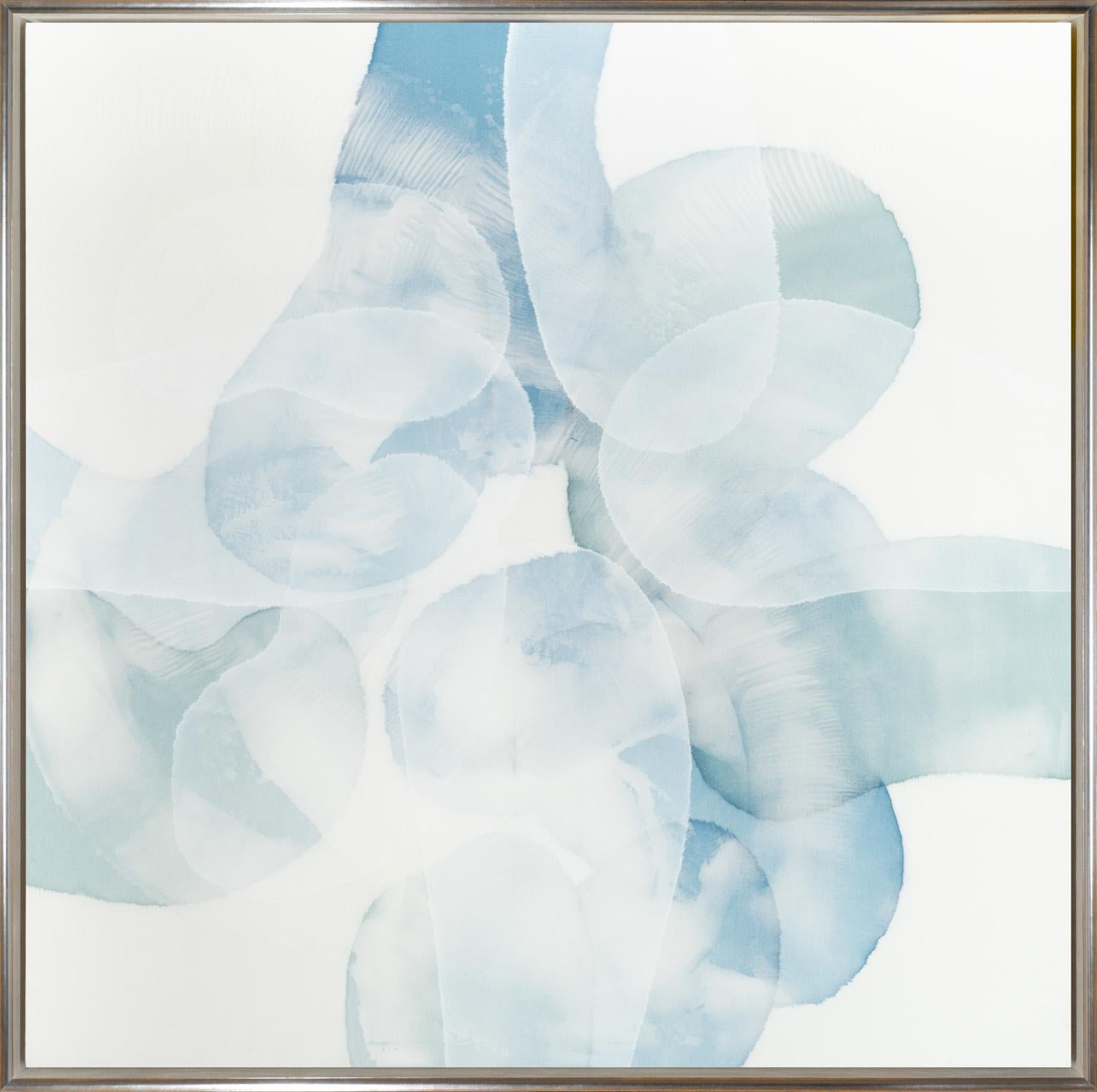 "Let's All Meet in the Middle" is a framed acrylic work on canvas by Charlie Bluett with abstract asymmetric forms in aquatic shades of blue and wisps of white. The ethereal layers of paint evoke the opaque serenity of the sea glass that inspires