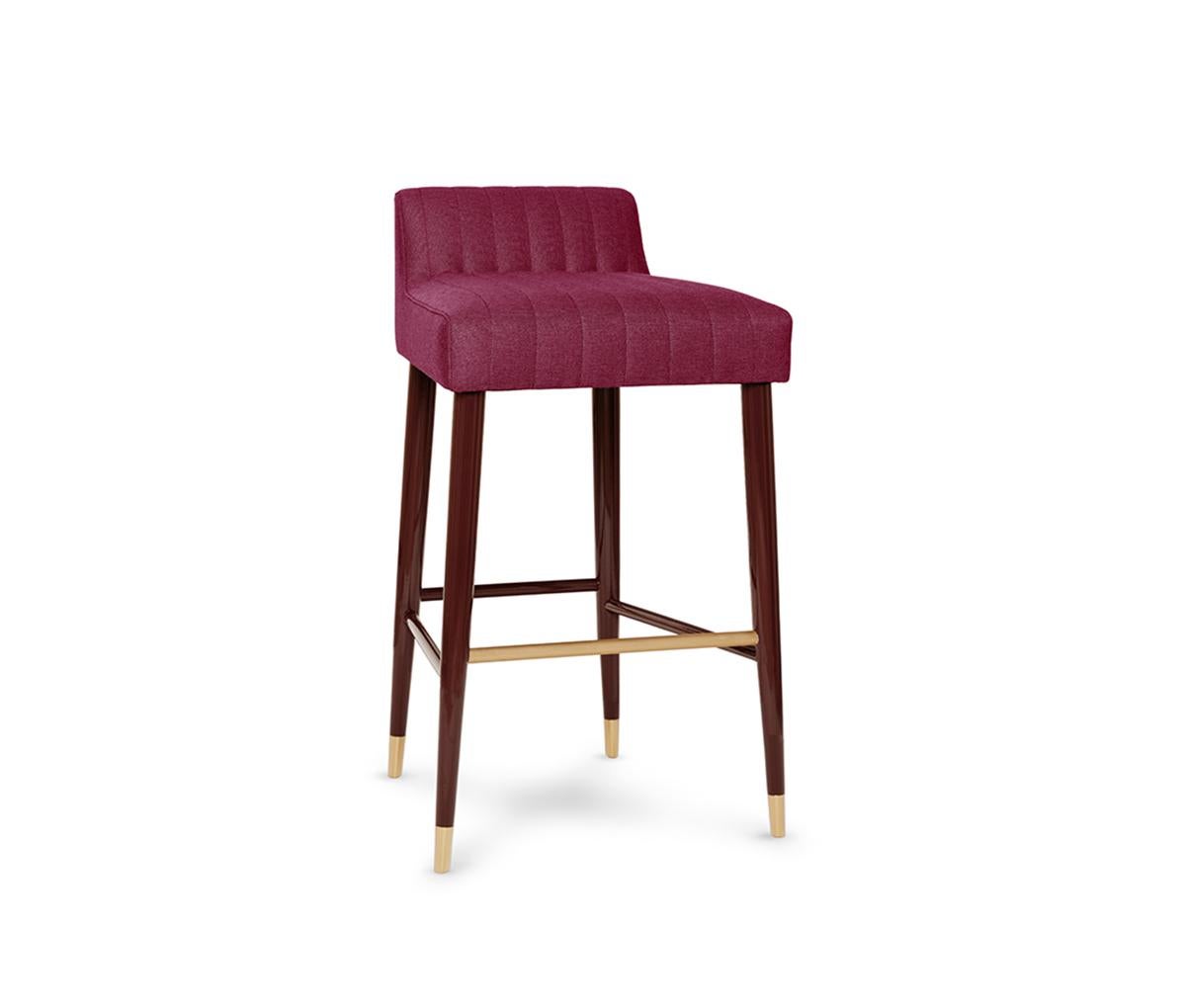 Charlotte Counter Stool by Munna
Dimensions: D 47 x W 46 x H 82 cm. SH: 70 cm.
Materials: Solid wood, foam, brass, and upholstery.
Finish: Upholstery: Twill FR, ref. Raspberry, TFR11.  Legs: Raspberry gloss lacquer. Metal detail: Brushed Brass. Feet
