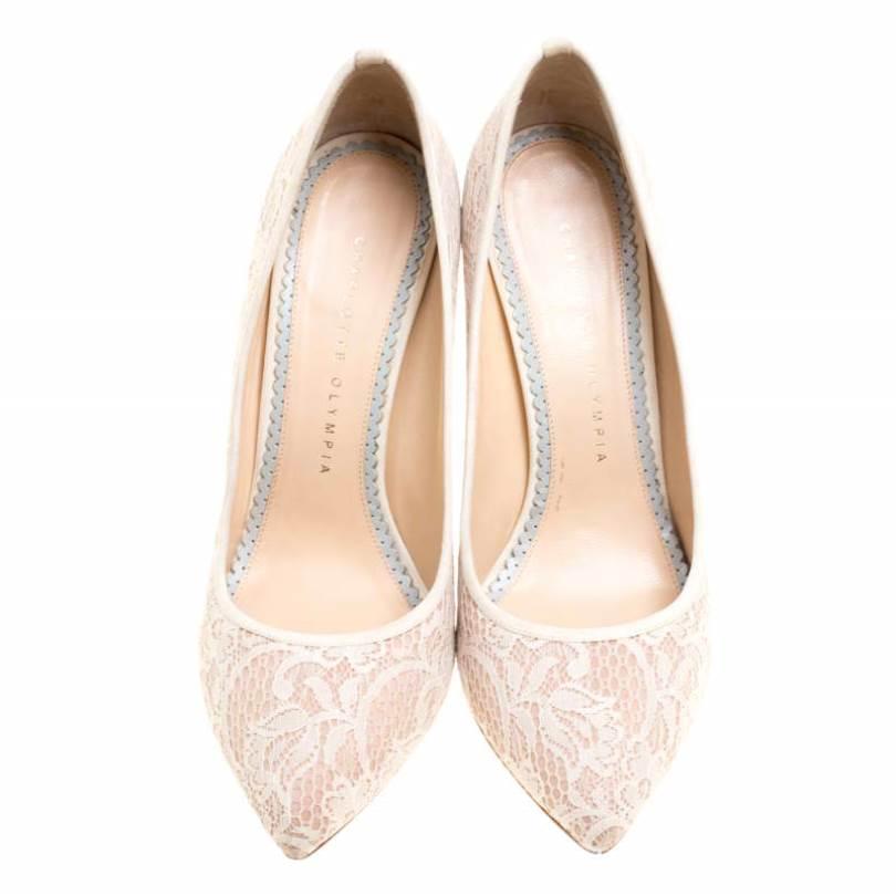 These beige Charlotte Olympia pumps are flowing with utmost splendour. They are covered in lace, styled with pointed toes and beautifully balanced on 11.5 cm heels. You'll love owning this pair!

Includes: Original Box, The Luxury Closet Packaging

