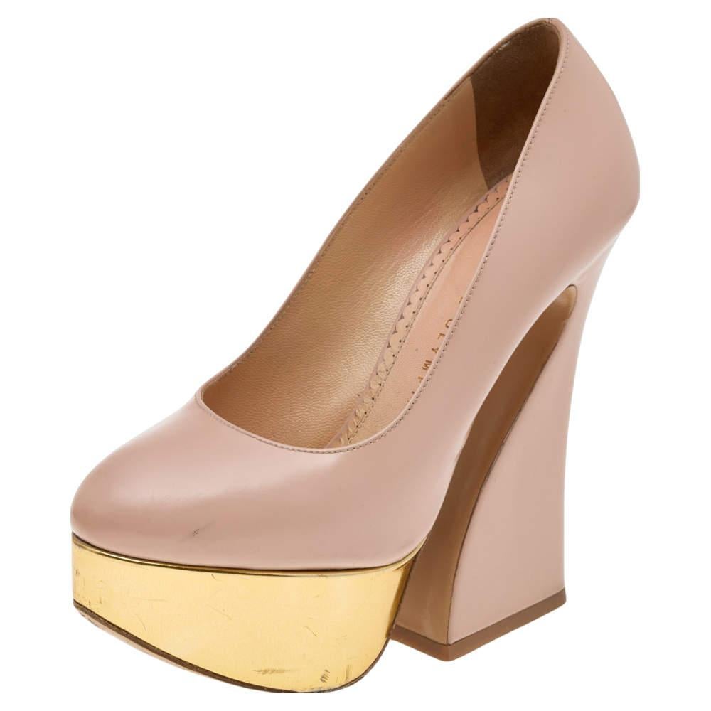 With her bold and stylish creations Charlotte Olympia has paved her way into every womans wardrobe These pumps are crafted from leather and feature covered toes gold tone platforms and beautifully curved heels.