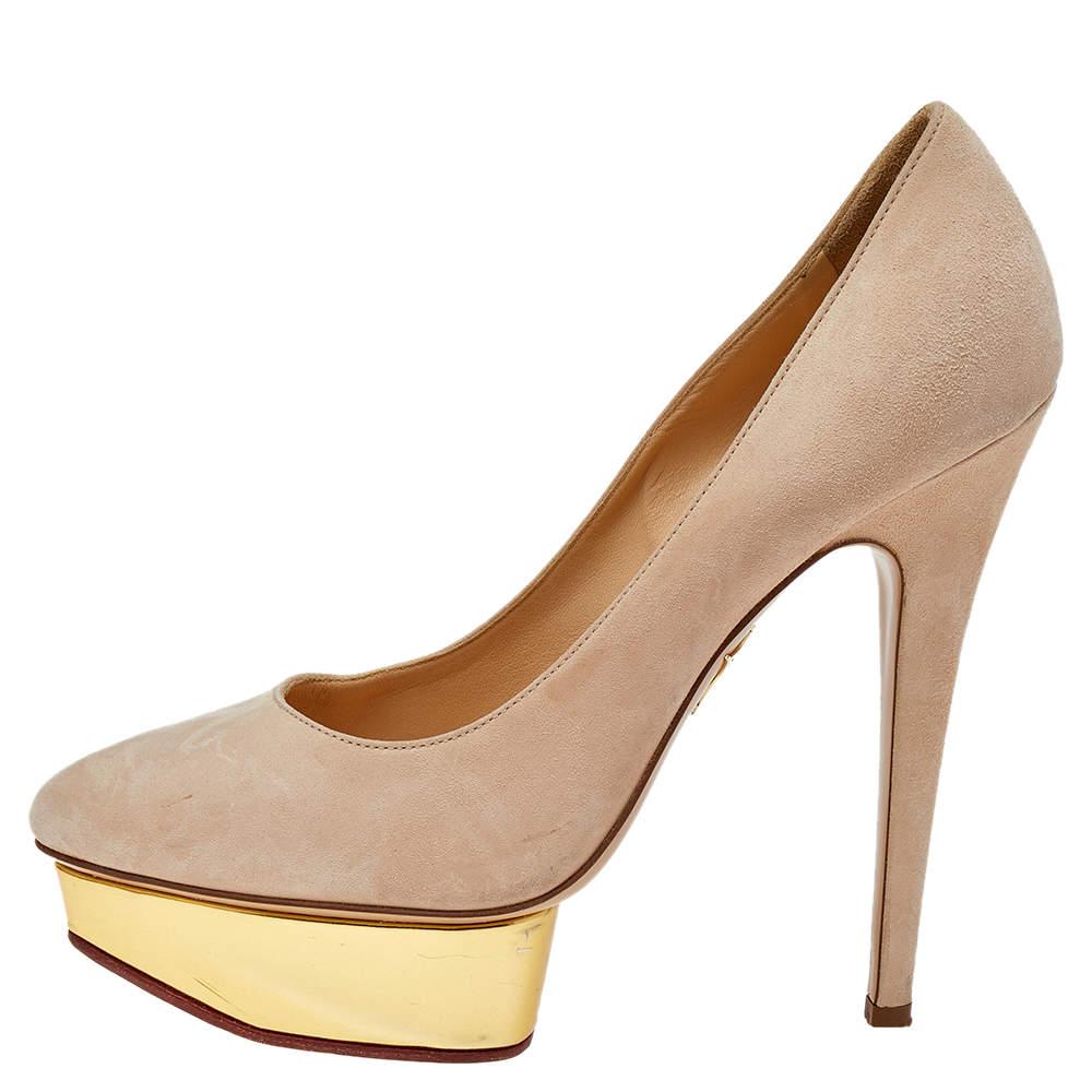 Own this meticulously designed pair of Charlotte Olympia pumps today and dazzle everyone whenever you step out Crafted out of suede and lined with leather on the insoles this creation is from their Dolly collection. They have been beautified with