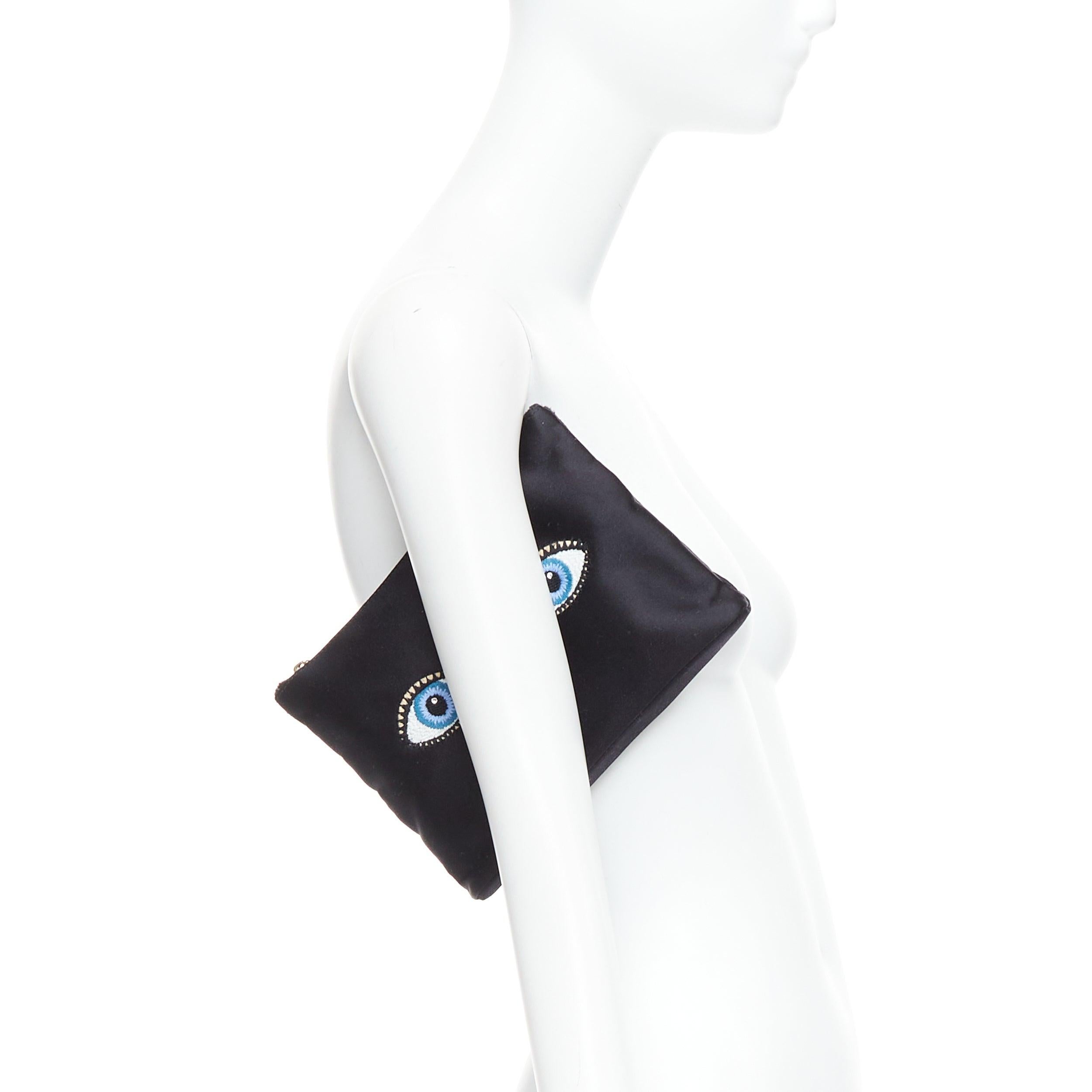 CHARLOTTE OLYMPIA black satin surrealist blue eye embroidery pouch bag
Reference: SNKO/A00502
Brand: Charlotte Olympia
Material: Fabric
Color: Black, Multicolour
Pattern: Cartoon
Closure: Zip
Lining: Pink Fabric
Made in: Italy

CONDITION:
Condition: