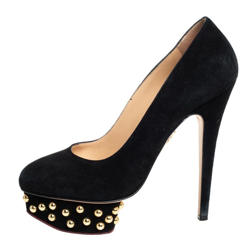 These Dolly pumps by Charlotte Olympia will bring a touch of feminine sophistication to your ensemble. These smooth suede pointed-toe pumps are beautifully elevated on 14 cm heels supported by studded platforms. Wear them to parties and get admiring