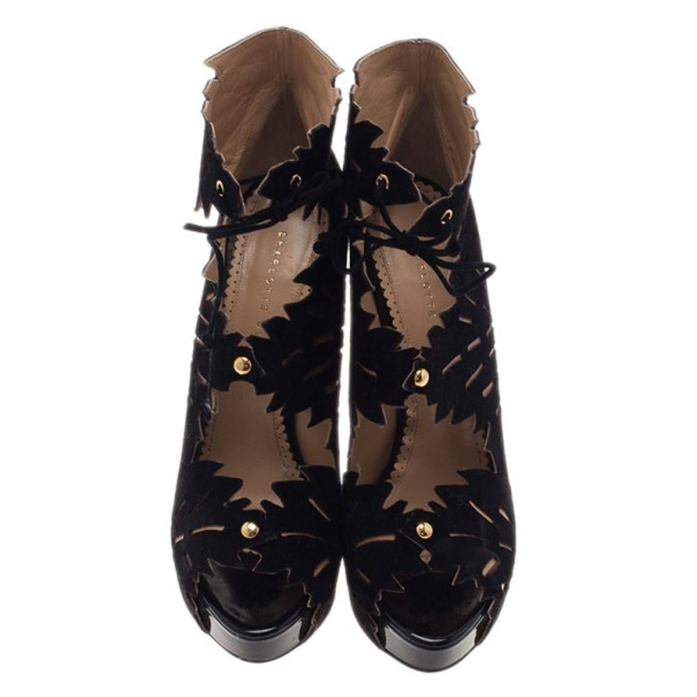 Designed with edgy leaf cutouts, these Charlotte Olympia Eve Leaf Booties are to die for! Made from suede, they feature 2 cm platforms, self-ties at the ankles, leather lined insoles and 15 cm heels.

Includes: Original Dustbag