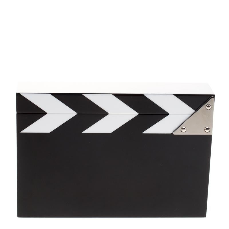 Have all eye on you with this quirky Charlotte Olympia Pandora box clutch. Artfully designed in a black and white Perspex, this clutch features a sturdy silhouette and detailed with silver-tone hinges at the top. It comes with a zipper golden pouch