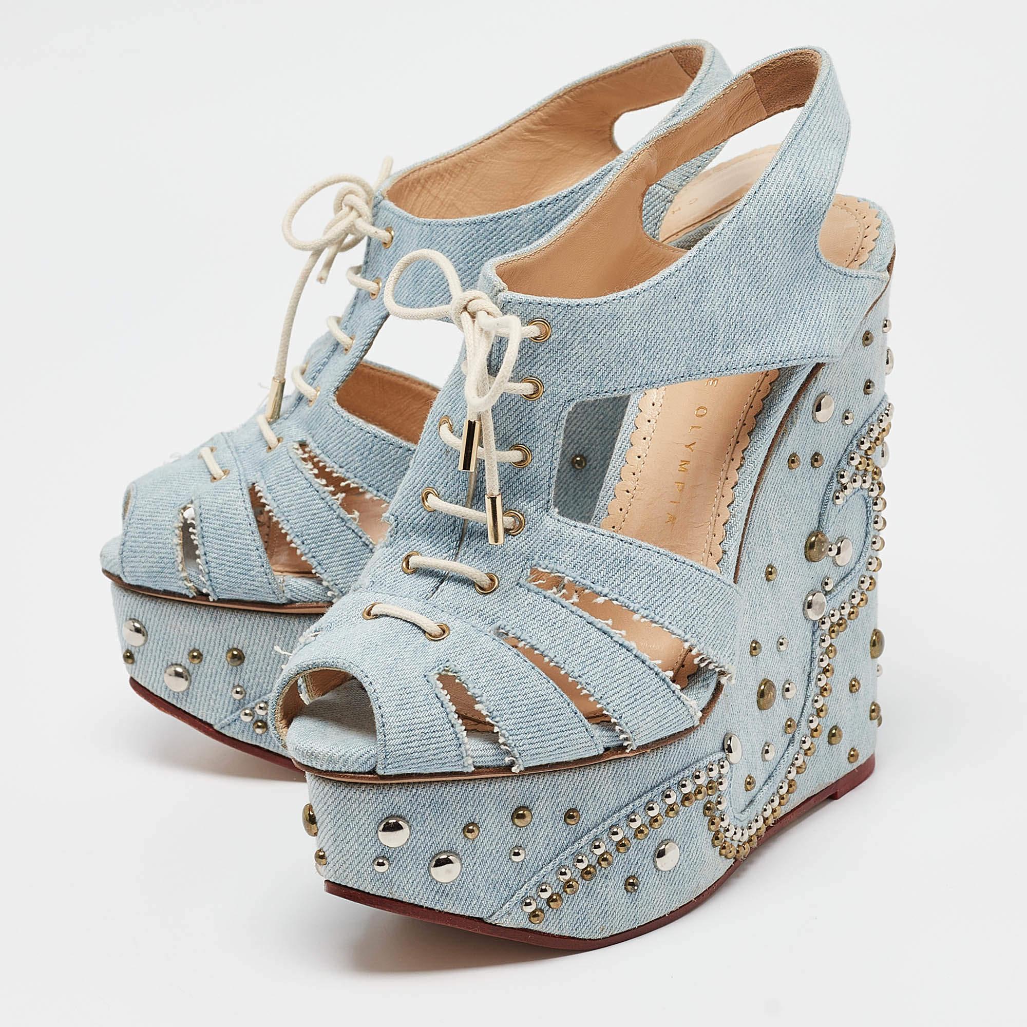 These sandals from Charlotte Olympia will lend a stylish and playful edge to your feet. These denim fabric sandals are edgy and look fashionable and chic. They are styled with open toes cut out vamps with laces solid platforms 14 cm wedges heels