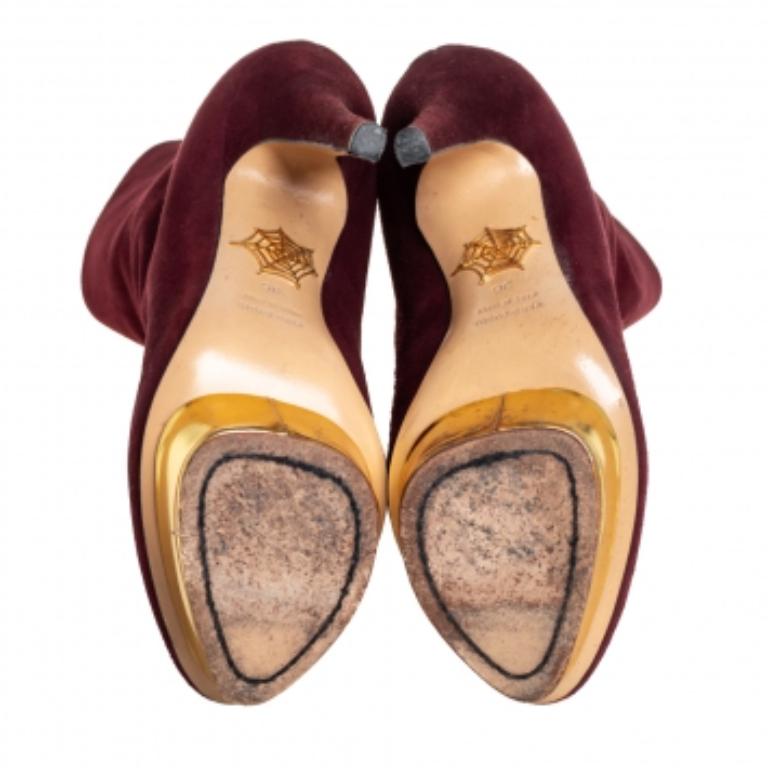 No fashion quest is complete without a pair of boots that stands out uniquely from one's closet. Like these Charlotte Olympia ankle boots that come crafted from burgundy suede and designed with a mix of luxury, style, and edginess. They feature back