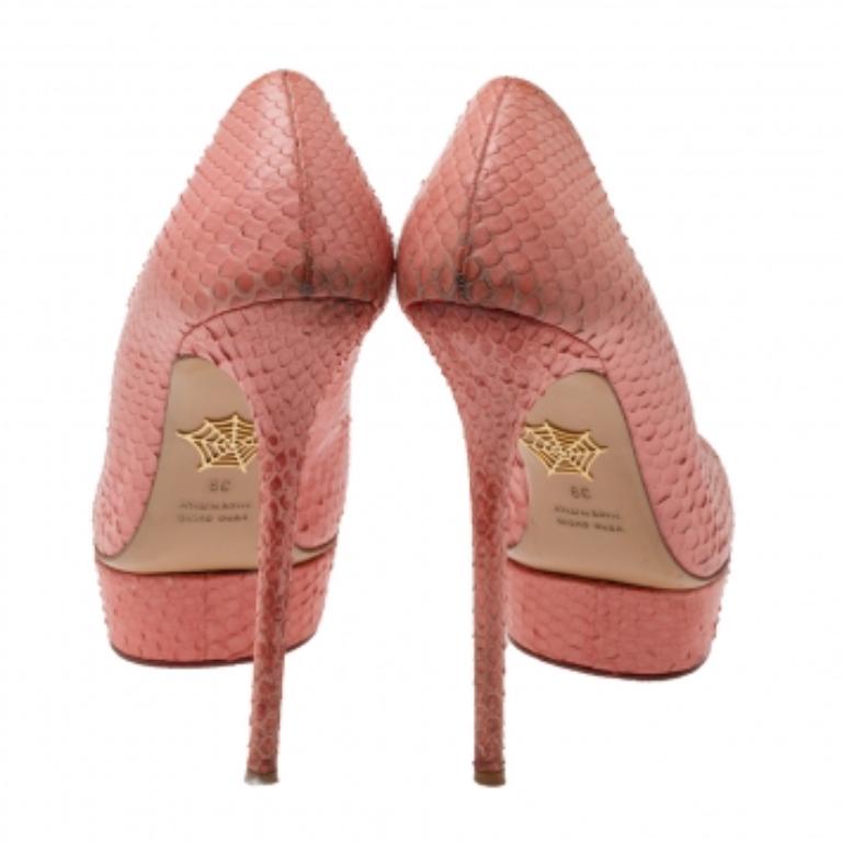 Own this meticulously designed pair of Charlotte Olympia pumps today and dazzle everyone whenever you step out! Crafted out of coral red python and lined with leather on the insoles, this creation is from their Dolly collection. They have been
