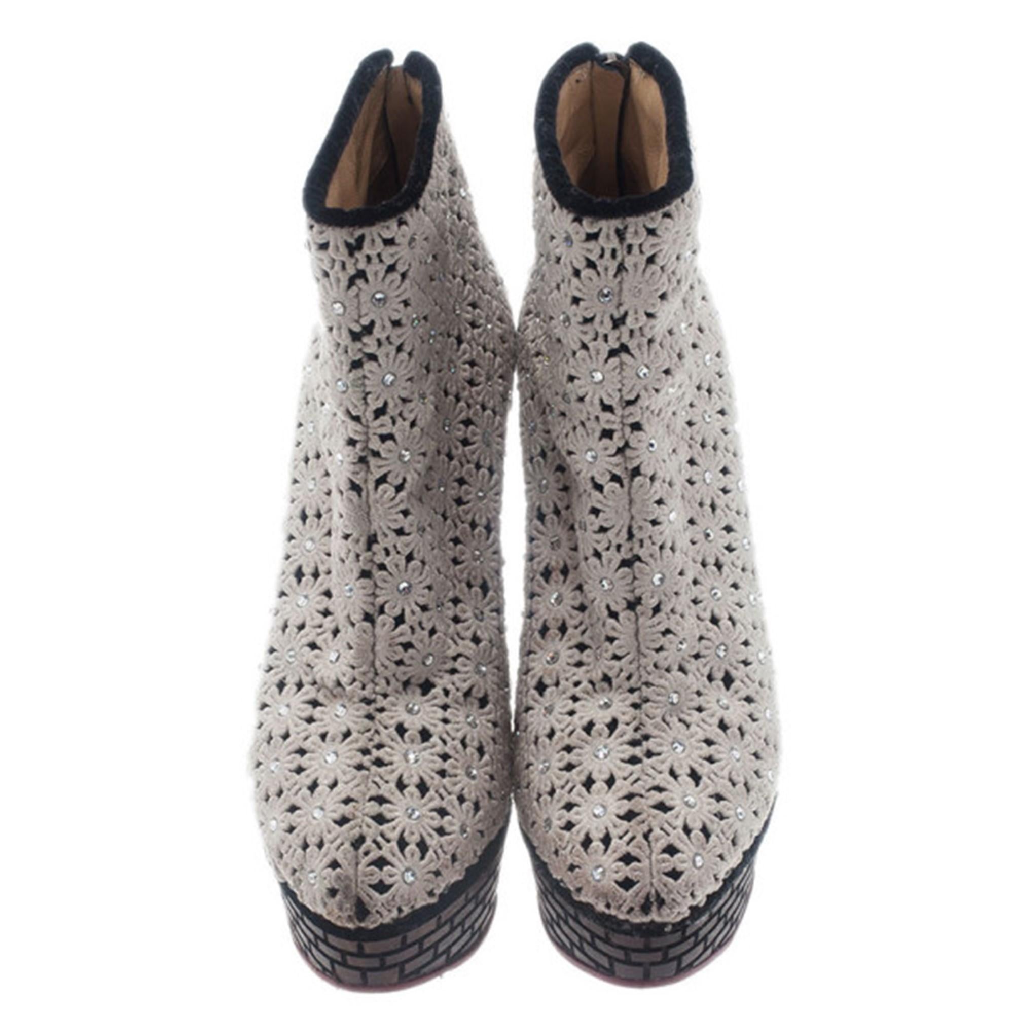 Finish off your look with these Charlotte Olympia Damsel In Distress Ankle Boots. Made from cream crocheted velvet, they feature perforated floral motifs all over, 13cm brown wooden heels and back zippers. They are leather lined with classic