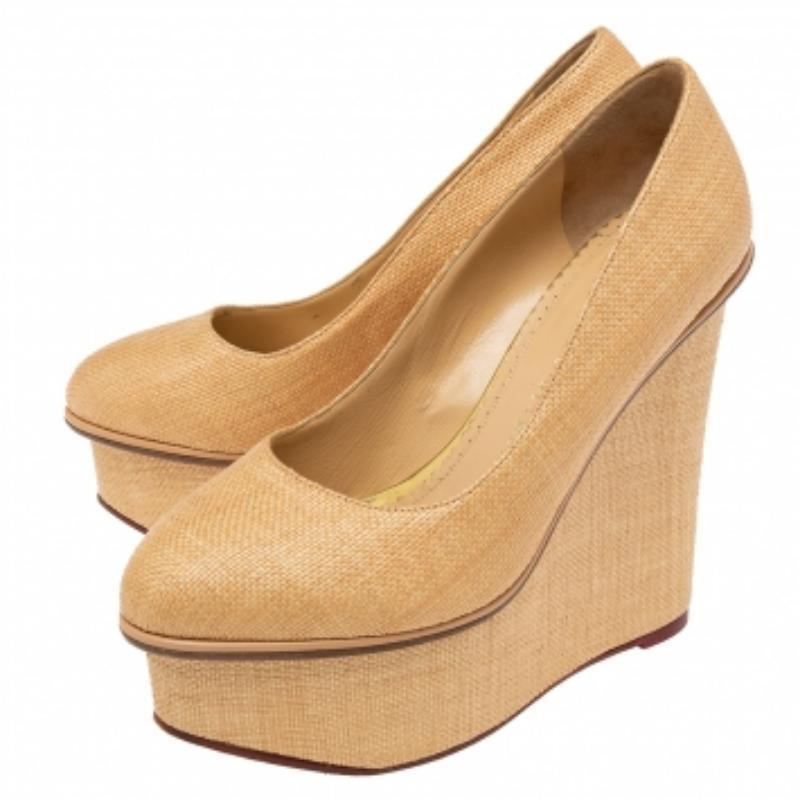 Presented by Charlotte Olympia, these Carmen pumps are designed with selective features to offer elegance and poise. They are made from cream-yellow raffia on the exterior. They have platforms, wedge heels, and a slip-on closure. Exude charm by