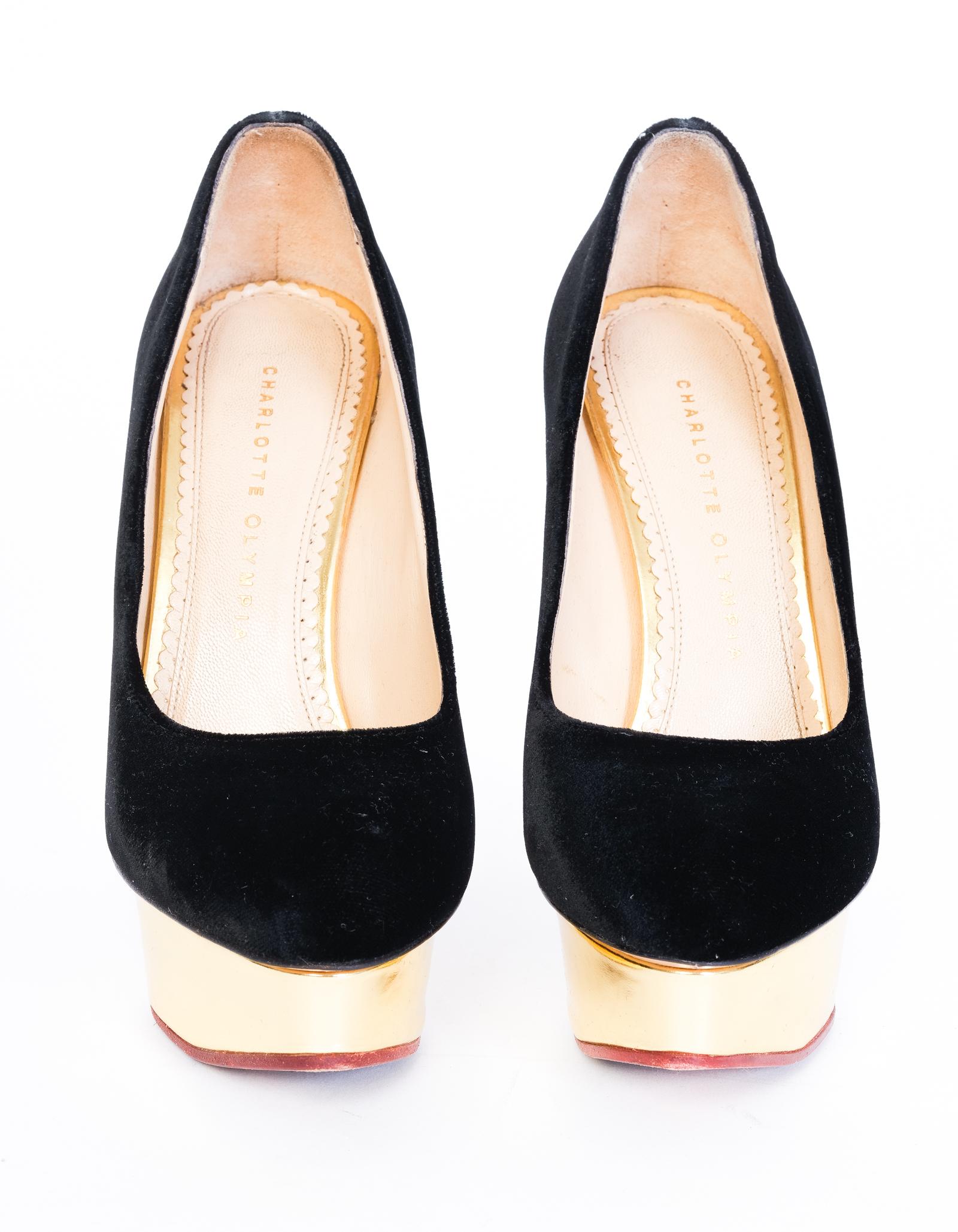 Charlotte Olympia Dolly black suede heels with metallic platforms in Women's EU 37.5 / 6.5 US. Featuring a black suede exterior and heels with a hight of 5.5 inches, a beige leather interior and bottom, gold toned platforms with a height of 1.5