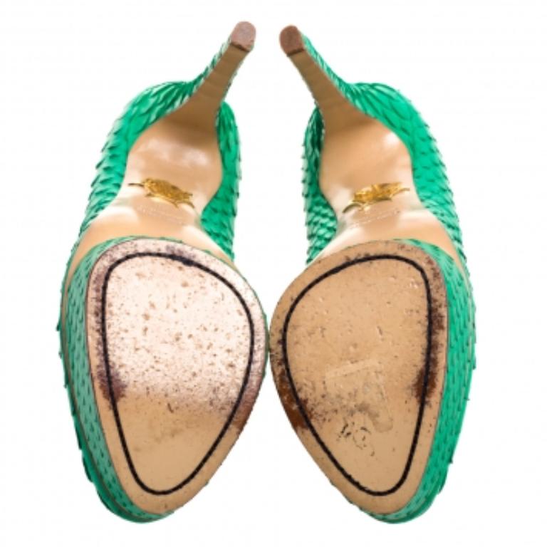 Statement pumps for you to outshine everyone else! These green Charlotte Olympia beauties are crafted from python leather and feature almond toes. They come endowed with comfortable leather-lined insoles and will lift you up gracefully with their
