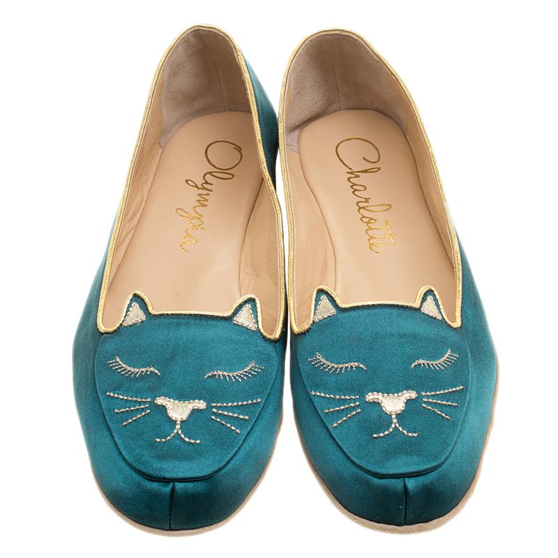 For that element of quirk and fun to your ensembles, opt for this stunning slipper set pair from the house of Charlotte Olympia. It features a stunning green satin body and detailed with cat motif on the front. It comes with a coordinating pouch and