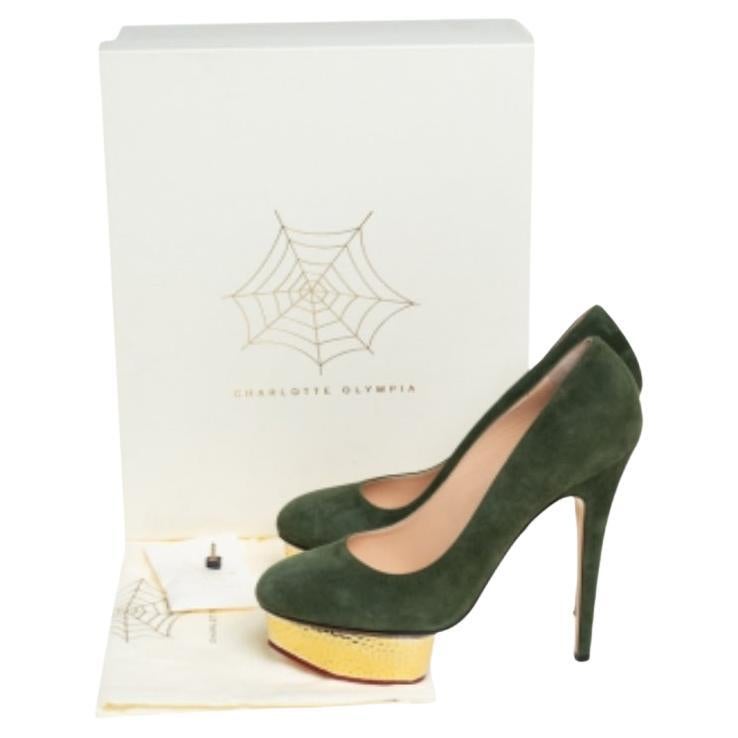 Own this meticulously designed pair of Charlotte Olympia pumps today and dazzle everyone whenever you step out! Crafted out of suede and lined with leather on the insoles, this creation is from their Dolly collection. They have been beautified with