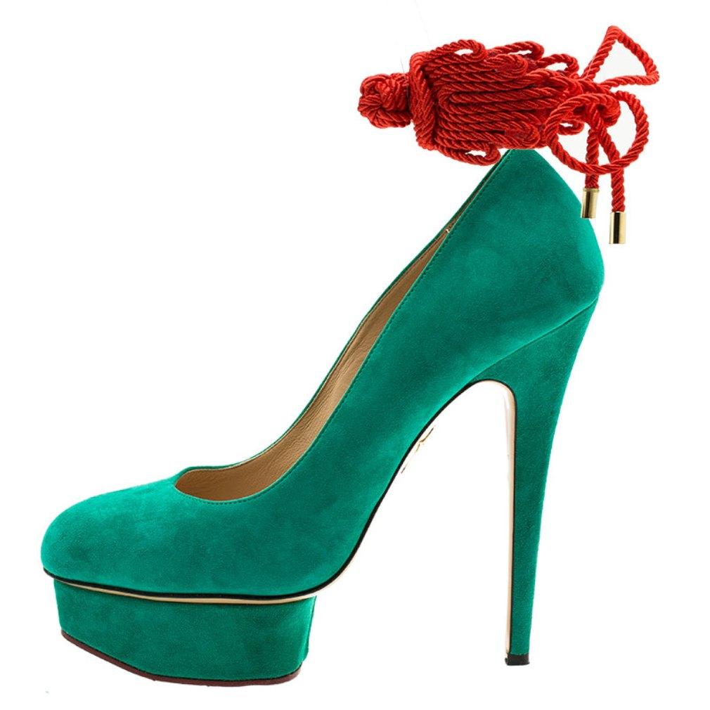 These Charlotte Olympia Dolly pumps will brighten up any look. This fun pointed toe shoes are made from green suede and are complemented with red ankle rope strings. The covered platforms come with 15.5 cm pointed heels. The insoles are leather