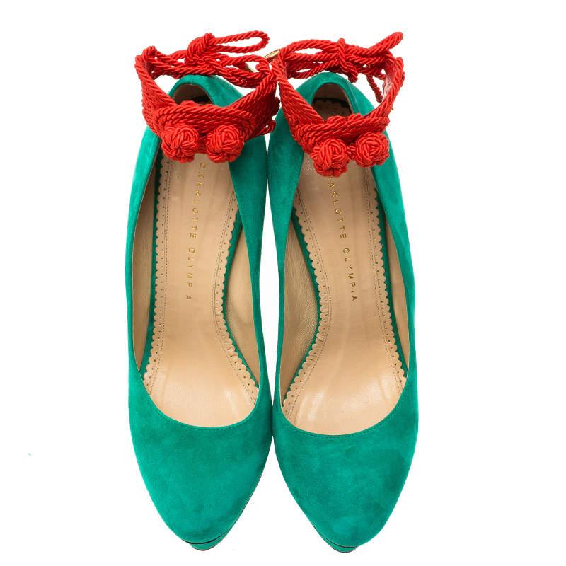 These Charlotte Olympia Dolly pumps will brighten up any look. This fun pointed toe shoes are made from green suede and are complemented with red ankle rope strings. The covered platforms come with 15.5 cm pointed heels. The insoles are leather