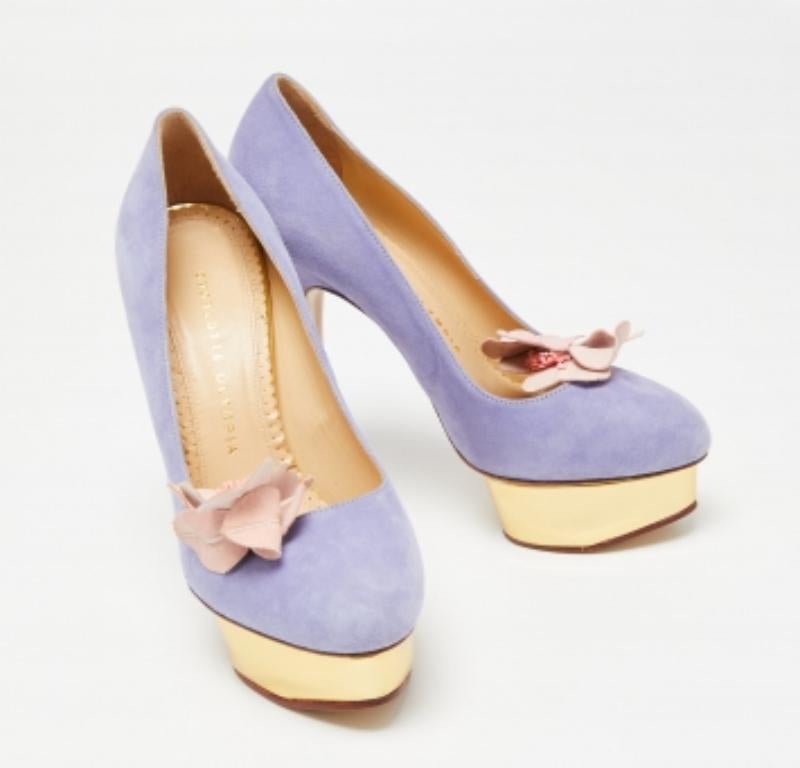 Make a statement with this pair of Charlotte Olympia Dolly pumps. Crafted out of suede and lined with leather on the insoles, this creation is beautified with high heels, platforms, and a floral accent on the uppers.