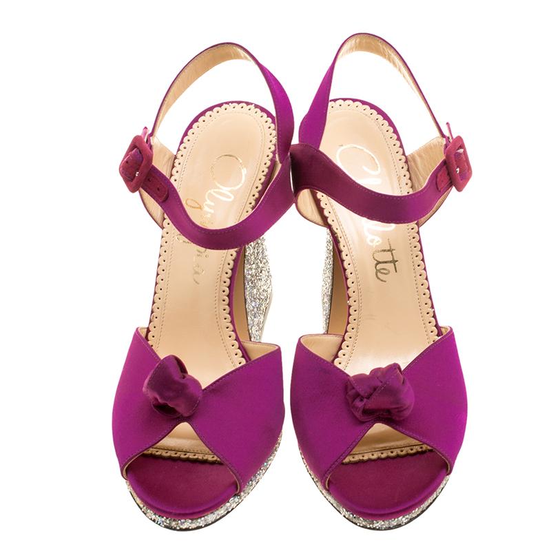 What beauty are these sandals from Charlotte Olympia! Carrying knotted uppers in satin and buckle ankle fastenings, these sandals are fashionable and just right for a glamorous touch. They'll help you stand tall with the glittering 11.5 cm heels