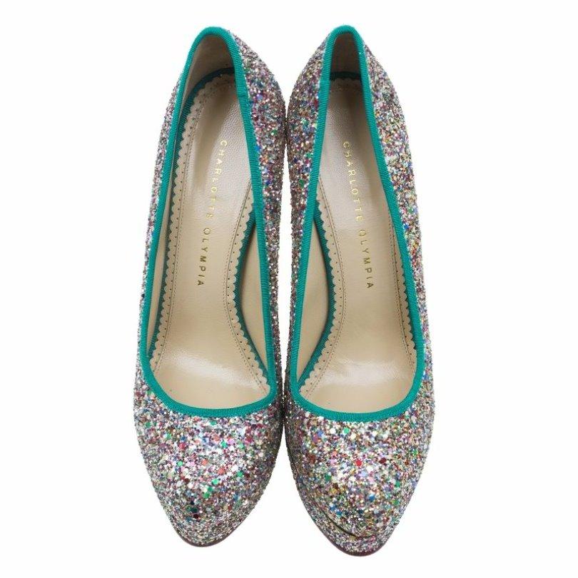 Add glitters to any party outfit with these ravishing Charlotte Olympia pumps which feature multi-colored shimmers. The contrasting green grosgrain trims enhance the overall look of these almond toe capped platforms. The insoles are leather lined in