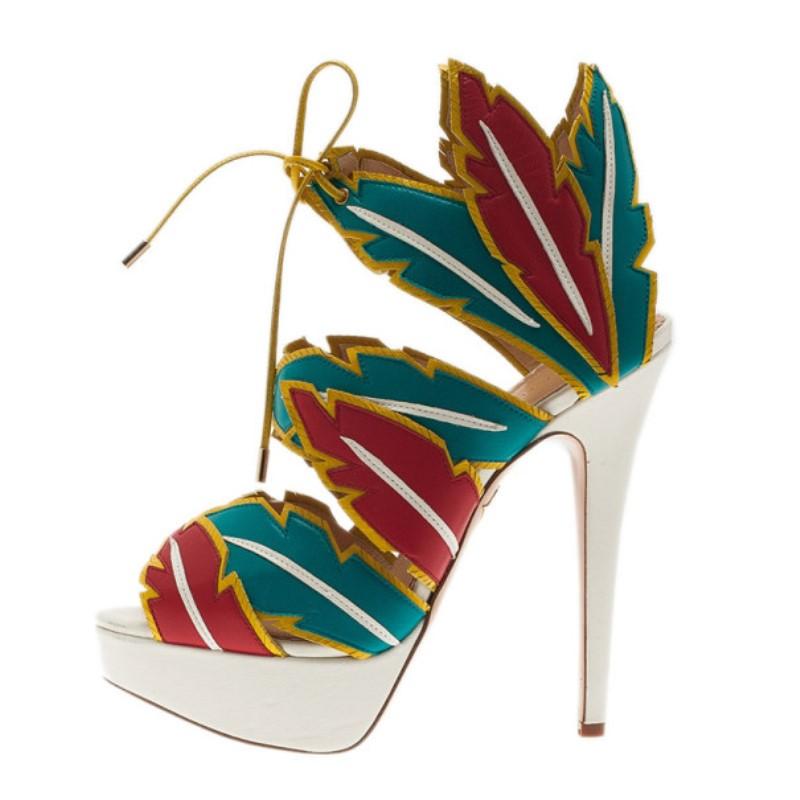 Designed with edgy feather cutouts, these funky Charlotte Olympia sandals are to die for! Made from suede, the design is inspired by the native American west culture. They have 3.5 cm platforms, self-ties at the ankles, leather lined insoles and