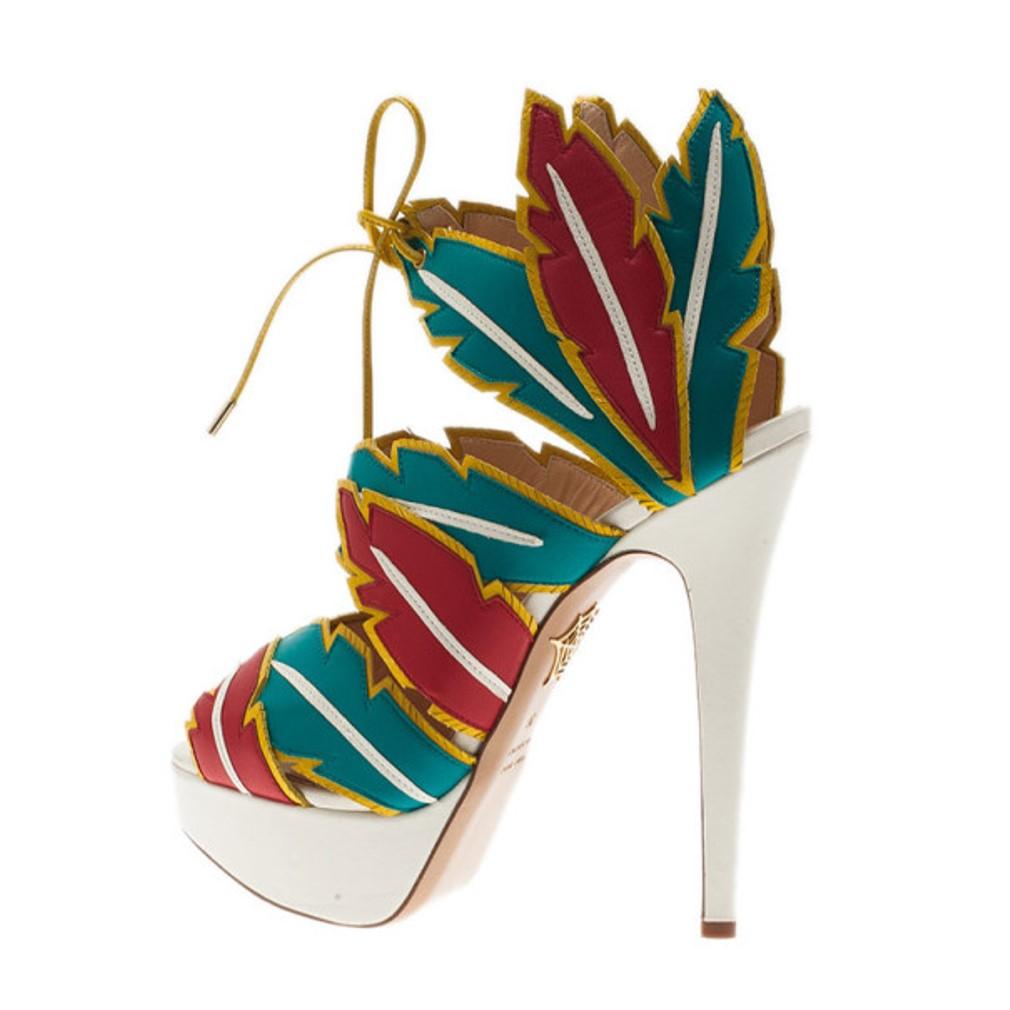 Designed with edgy feather cutouts, these funky Charlotte Olympia sandals are to die for! Made from suede, the design is inspired by the native American west culture. They have 3.5 cm platforms, self-ties at the ankles, leather lined insoles and