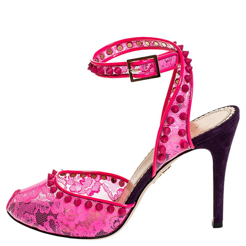 These Charlotte Olympia sandals emit a sense of grace. Crafted from neon pink lace-printed PVC, they feature studs, ankle fastenings and 10 cm heels. Made in Italy, these sandals are indeed going to take you to a world of glamour.

Includes: