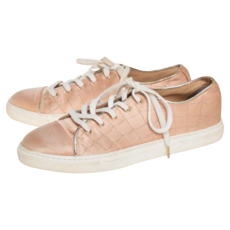 Known for her fashionable designs, Charlotte Olympia is a name known well by shoe lovers. These sneakers are crafted from peach satin and designed with round toes and beautiful web detailing. The shoes are leather-lined on the insoles to ensure