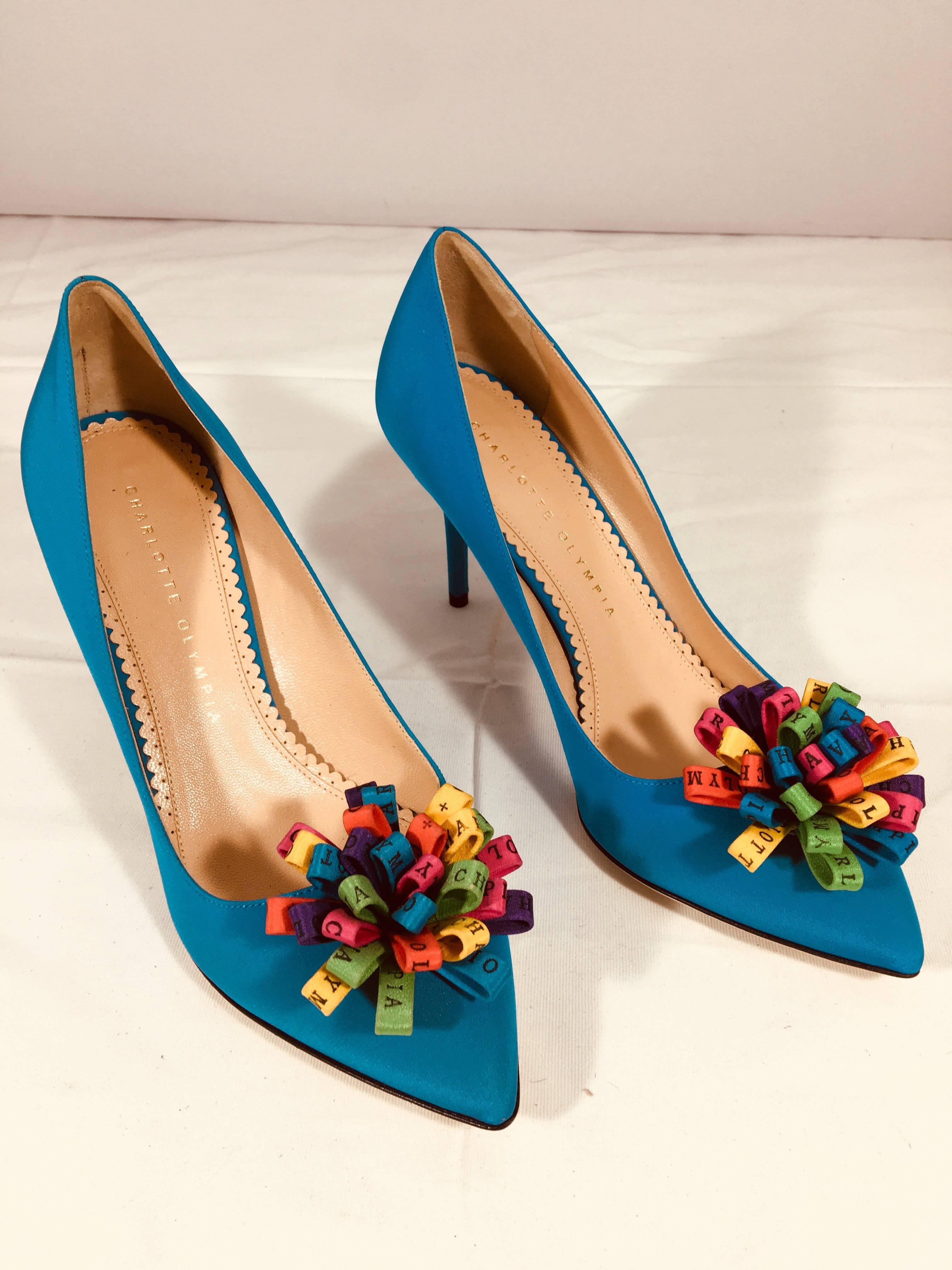 Charlotte Olympia Blue Satin Pointed Toe Heels with Multi-Color Pom Poms at Toe.