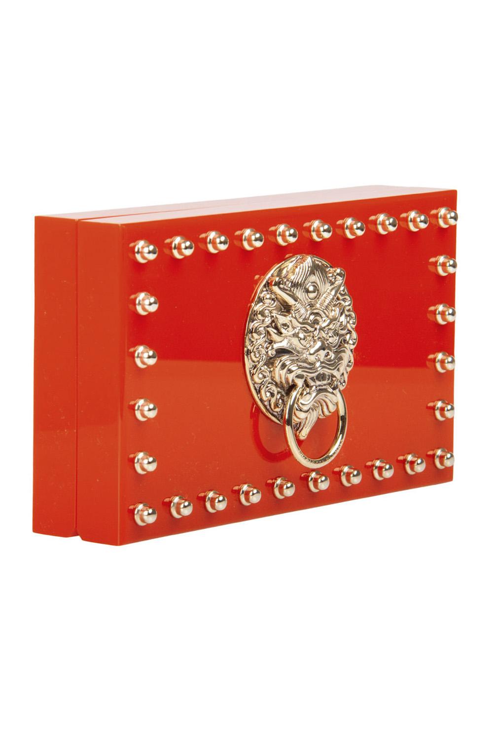 This edgy version of the famous Pandora Box clutch from Charlotte Olympia comes with a royal touch. Crafted from red Perspex, it has been styled with gold-tone studs and a motif at the centre and equipped with an interior housing the brand label.
