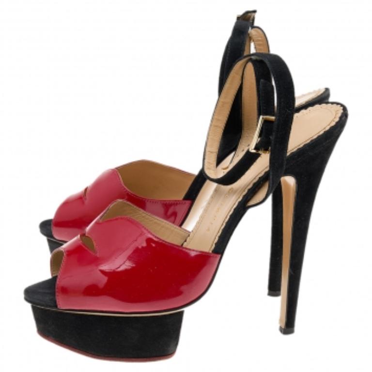 These sandals from Charlotte Olympia deliver style beautifully! They feature patent leather uppers in red, simple buckle fastening at the ankles in black suede, high platforms, and stiletto heels. You'll love wearing these!