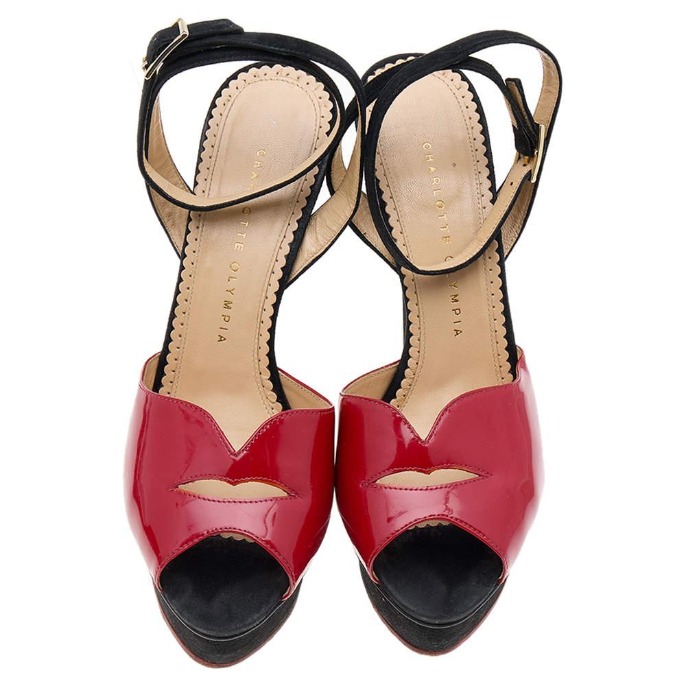 These sandals from Charlotte Olympia deliver style beautifully! They feature patent leather uppers in red, simple buckle fastening at the ankles in black suede, high platforms, and stiletto heels. You'll love wearing these!

