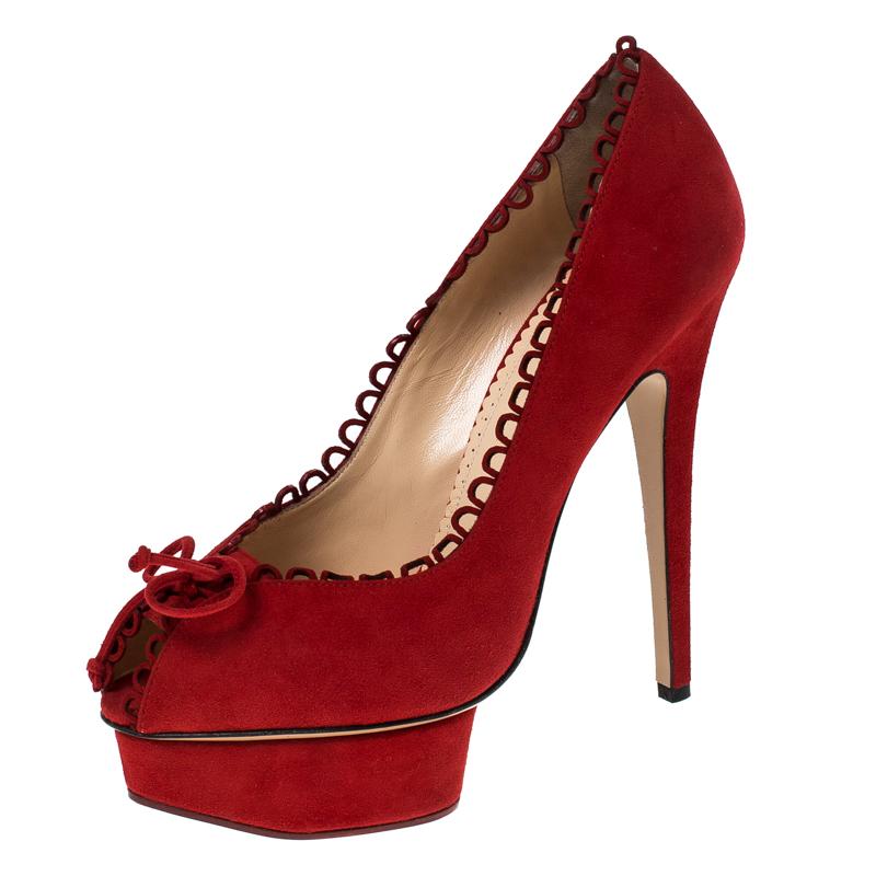 These pumps from Charlotte Olympia are love at first sight! The red beauties are exquisitely crafted from suede and designed to please the eyes of the beholder. They flaunt scalloped trims with small ties above the peep toes, well-cut platforms and