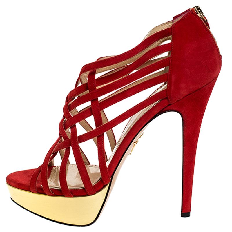 These fashionable sandals from Charlotte Olympia can give your entire ensemble a makeover. These suede sandals are edgy, look fashionable and chic. Crafted from quality suede, they come in a striking shade of red. These strappy sandals are equipped