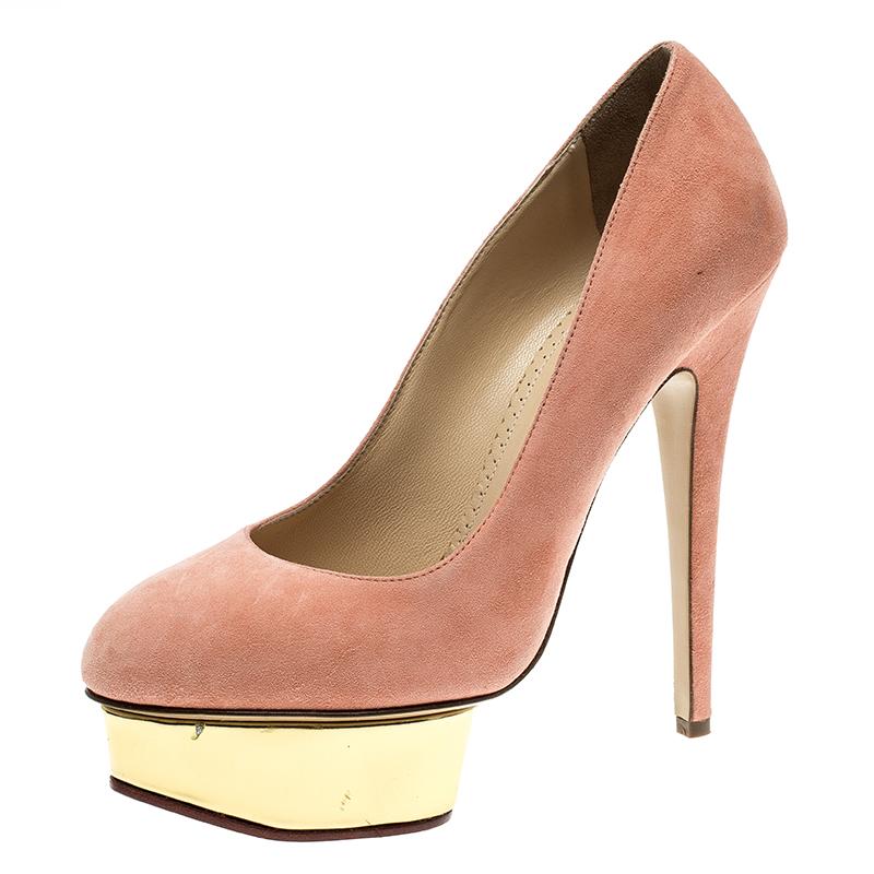 Own this meticulously designed pair of Charlotte Olympia pumps today and dazzle everyone whenever you step out! Crafted out of suede in a dreamy salmon hue and lined with leather on the insoles, this number is from their Dolly collection. They've