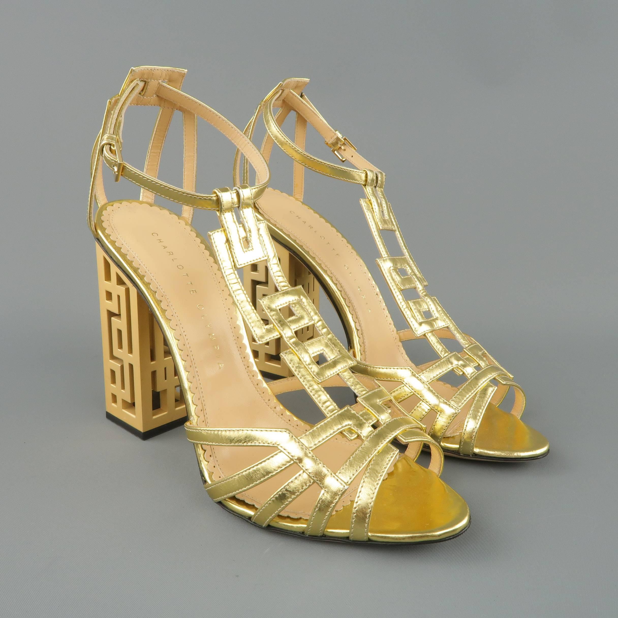 CHARLOTTE OLYMPIA sandals come in metallic gold leather and features a a thick cutout T strap and thick metal geometric cutout block heel. Made in Italy.
 
New without Tags.
Marked: IT 38.5
 
Measurements:
 
Heel: 4.5 in.

