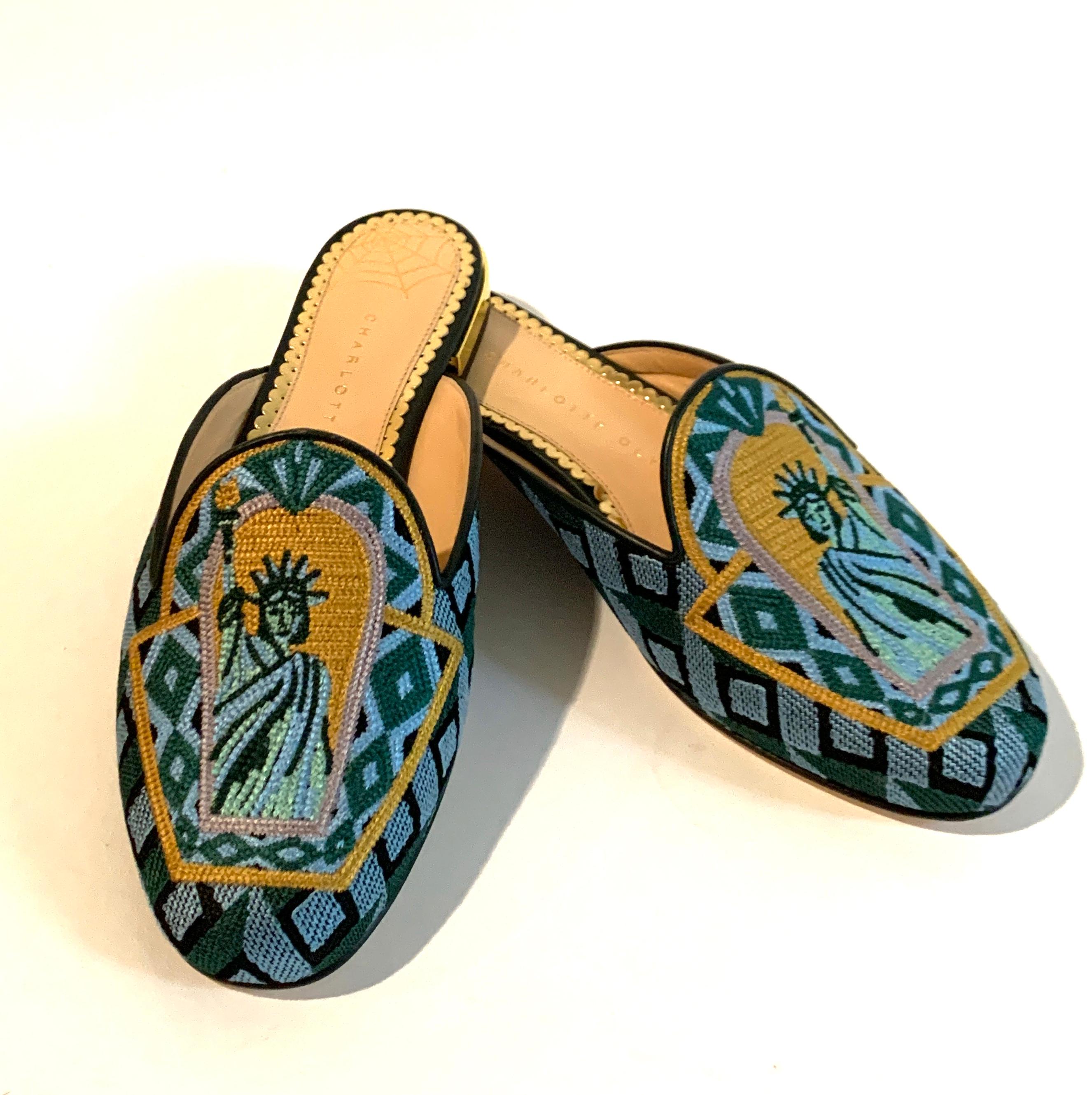 Charlotte Olympia Lady Liberty mule features the Statue of Liberty in embroidered needlepoint at upper. Gold tone heel. Canvas slide with leather soles. Slide on. 

Made in Italy.

Size IT 35, approximate US 5.

Excellent unworn condition. Box and