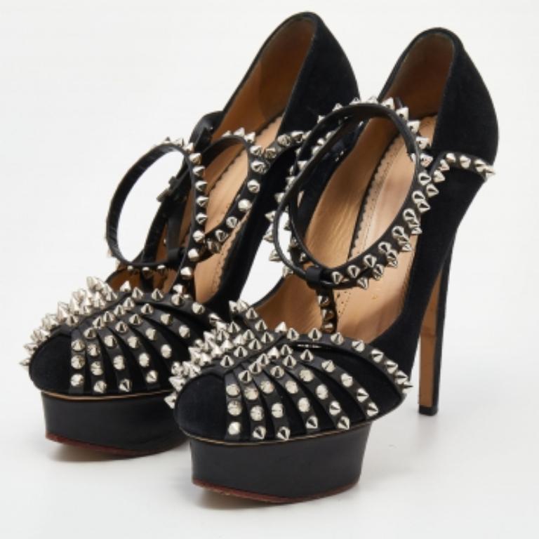 These black sandals from Charlotte Olympia, exuding a glamorous finish, are ideal for fashion-forward women. The exterior is beautifully designed with suede and is embellished with studs on all the straps, including the ankle straps that feature