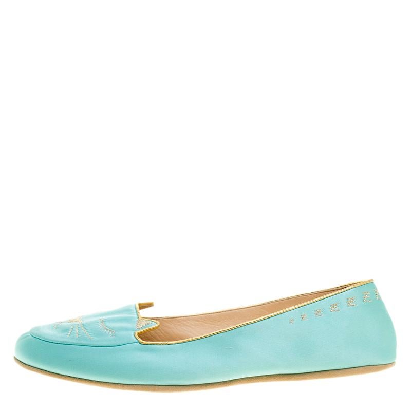 Constructed in the most elegant and beautiful teal blue satin fabric, these Charlotte Olympia Cat Nap slippers are a perfect addition to your summer wardrobe. With golden cat printed embroidery at the front along with cat ears, these shoes are