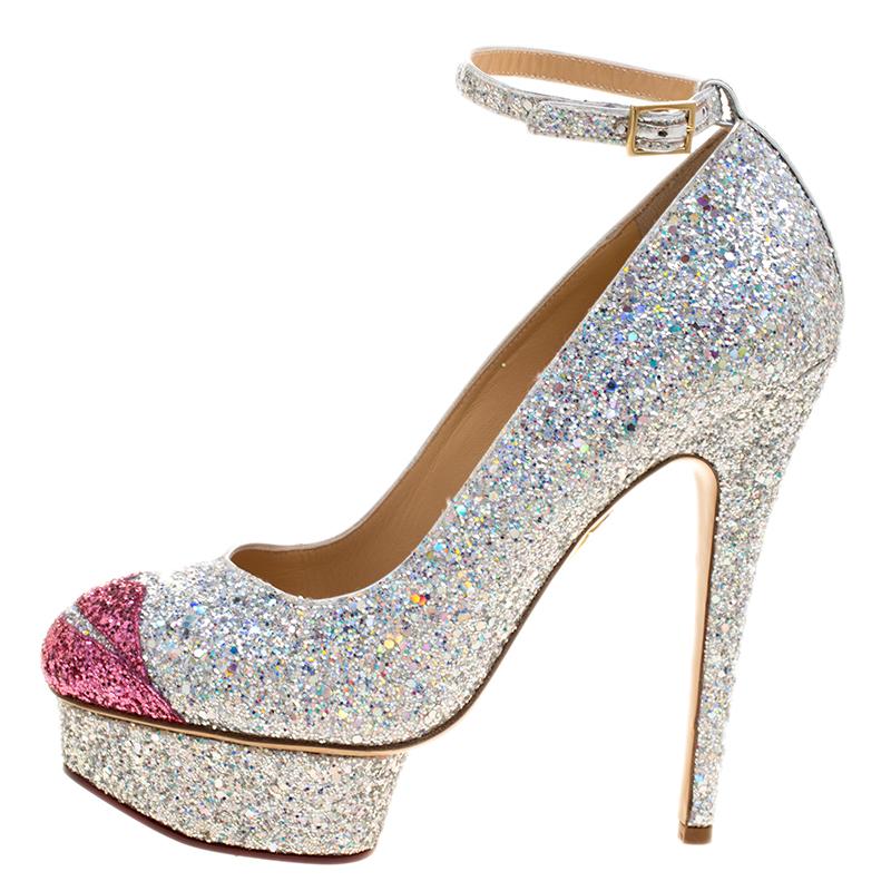 Walk and feel like a diva with these platform pumps from Charlotte Olympia. They've been wonderfully covered in glitter and designed with lips on the toes, well-cut platforms, buckle straps around the ankles and 15 cm heels to give you the right