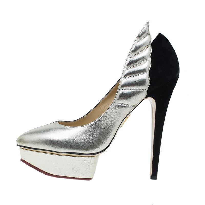 Fuse exotic with glamorous by flaunting this pair of Charlotte Olympia heels. Crafted with part black and part silver leather, they feature pointed toes over bold platforms. They are lined with beige leather and are accented with 15 cm heels. With