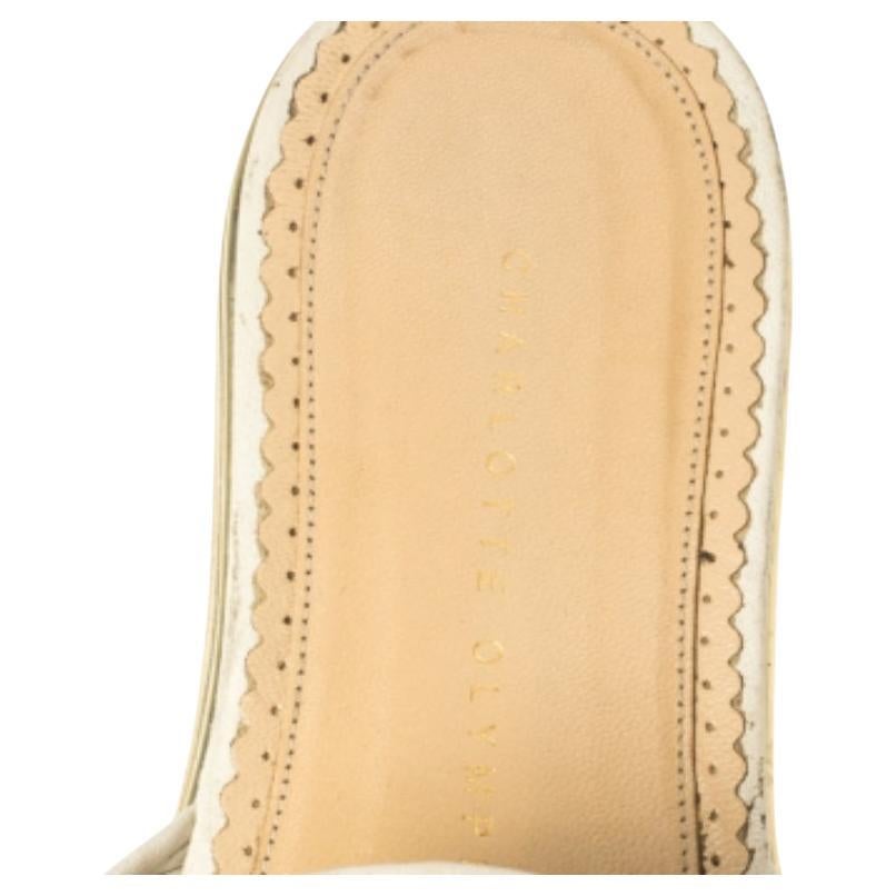 Offering comfort and style in equal proportions, these white slides from Charlotte Olympia are brought to life using leather. The vamps are detailed with wide knotted bows while the insoles are leather-lined and carry the brand's stamp. The durable