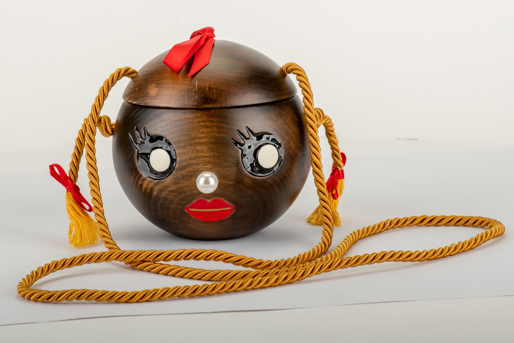 Collectible Charlotte Olympia wood face cross body bag. Yellow silk strap and red and pearl details .