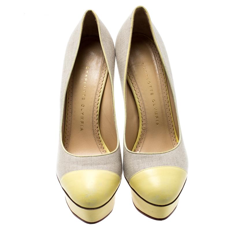 Own this meticulously designed pair of Charlotte Olympia pumps today and dazzle everyone whenever you step out! Designed with beige canvas and yellow leather, this creation is from the Dolly collection. They have been beautified with 14 cm heels and