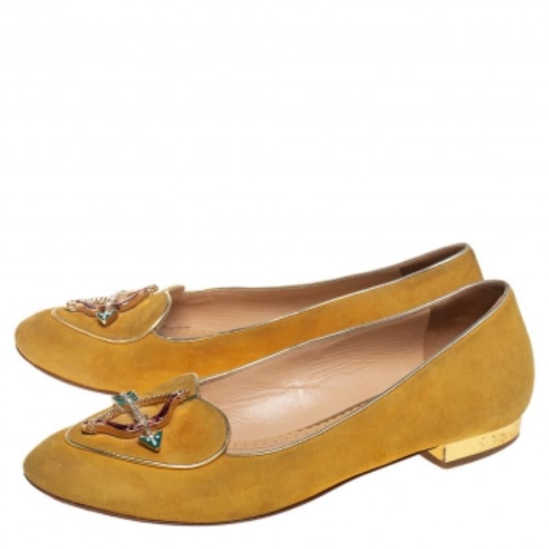 Adorn your feet with these pretty flats from Charlotte Olympia. They come crafted from suede and leather and styled with an embellished bow-arrow motif on the uppers and heels sized to provide comfort at every step. Flaunt these cute flats wherever