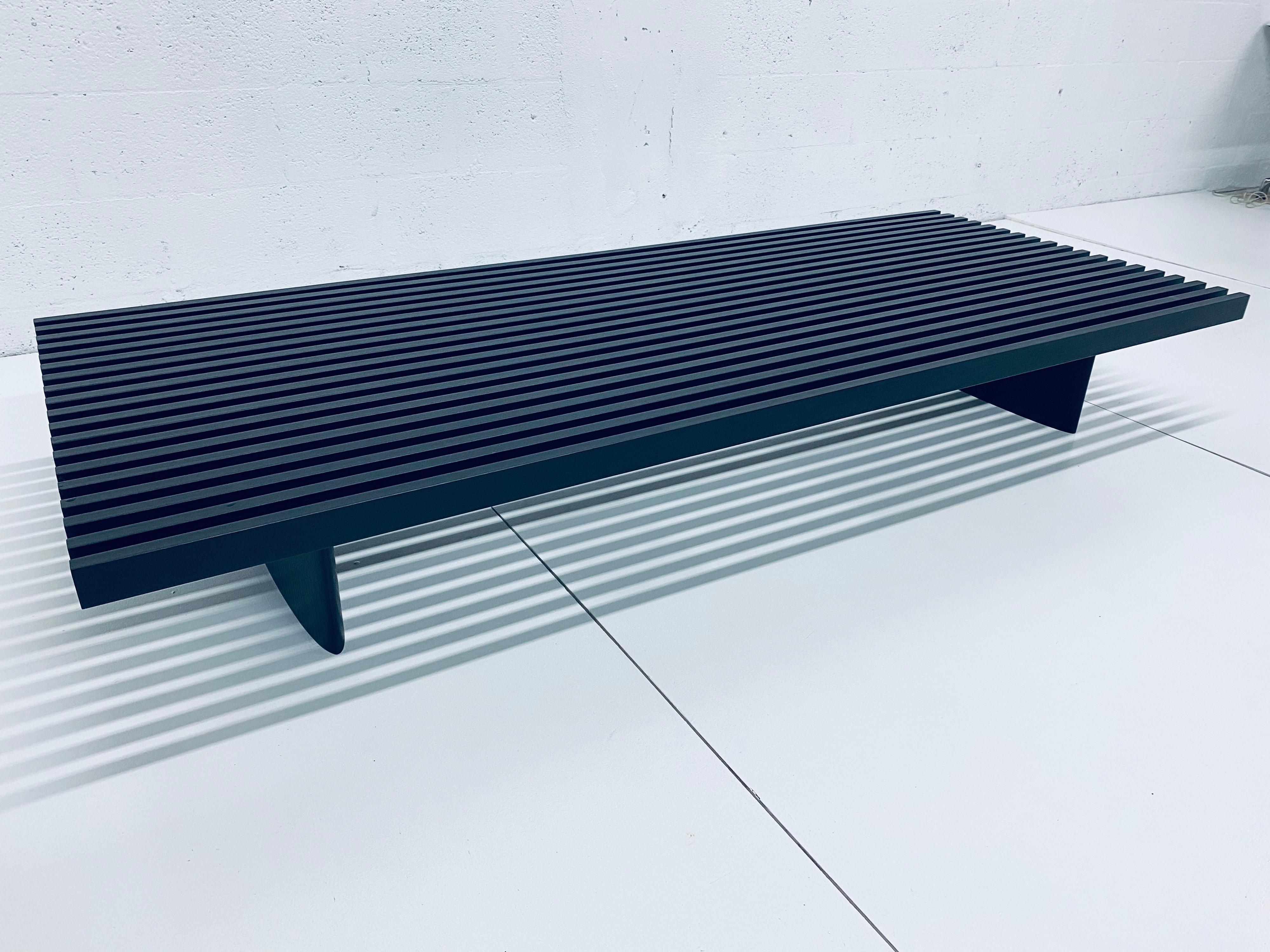 Ebony stained oak 514 Refolo coffee table or bench originally designed by Charlotte Perriand in 1953 and produced by Cassina in 2004. The surface consists of nineteen short slats arranged parallel: use as a table, as a bench or padded unit by simply